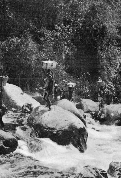 Crossing a Torrent on the Flanks of the Ruwenzori, from an article entitled To the Mountains of the Moon published in The Graphic October 27th 1906 by English Photographer